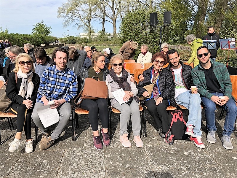 Survivors Mindu Hornick and Barbara Lorber seated with their families before the beginning of the commemorative service in Neustadt. 